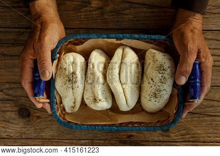 Fresh Halloumi Cheese In Old Senior Hands On A Parchment On Dark Rustic Background,in Wicker Basket 