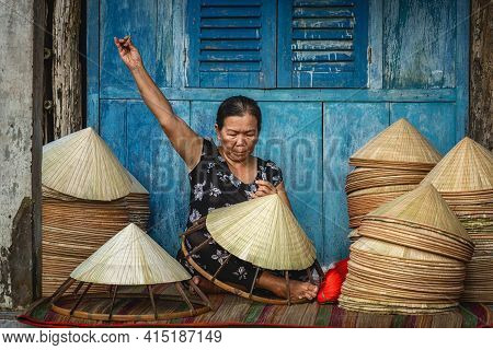 Vietnamese Old Woman Craftsman Making The Traditional Vietnam Hat In The Old Traditional House In Ap