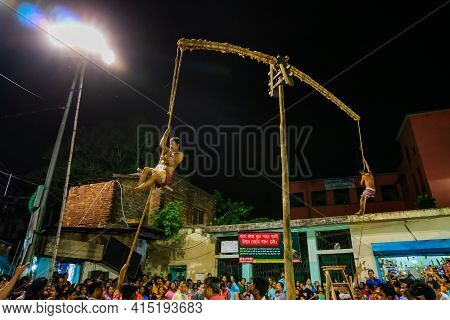 Howrah, West Bengal,india - 15th April 2019: Two Hindu Devotees Are Hanging From Pole In Air, At Nig