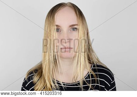 The Girl Looks In Front Of The Mirror At Her Oily Hair. Problematic Scalp And Increased Secretion Of