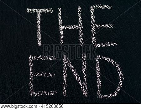 Writing The End In Chalk On A Rough Black Board To Indicate The End Of The Viewing Or Process. The C