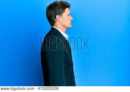 Handsome caucasian man wearing business suit and tie looking to side, relax profile pose with natural face with confident smile. 