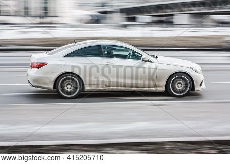 Moscow, Russia - March, 2021: Side View Rolling Shot With White Mercedes E-class C207 Car In Motion.