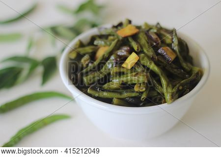 Stir Fried Beans With Chopped Coconut, Green Chillies, Turmeric And Curry Leaves Using Coconut Oil.
