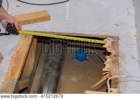Framing Contractor Measuring For Stubbed Up Domestic To Install Plywood Subfloor To Wood Joist