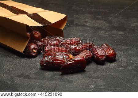 Dates On A Black Background. Dried Fruits. Dried Dates Lie Next To Each Other