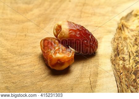 Dates On A Wooden Background. Dried Fruits. Dried Dates Lie Next To Each Other