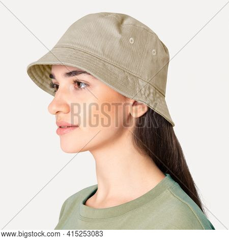 Beautiful woman in beige bucket hat fashion studio shoot