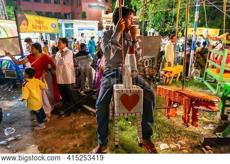 Howrah, West Bengal, India -14th April 2019 : Boy Child Riding On Nagordola- A Traditional Amusement