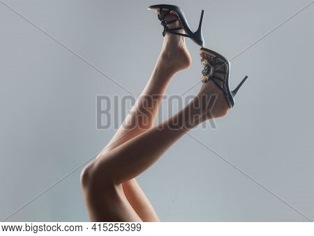 Sexy Woman Slim Legs. Undress Shoes. Trendy Fashion