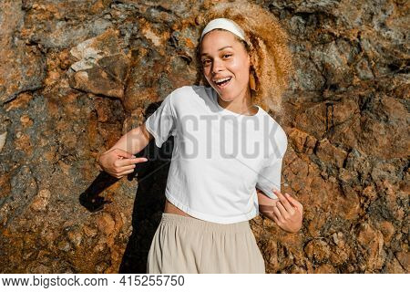 Happy woman in white crop top outdoor photoshoot
