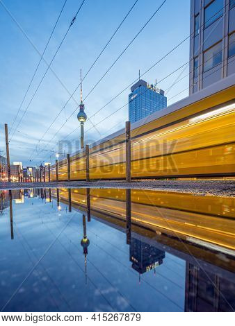 Berlin, Germany - March 21, 2021 - View Of The Famous Alexanderplatz With A Moving Tram At Dusk - Al