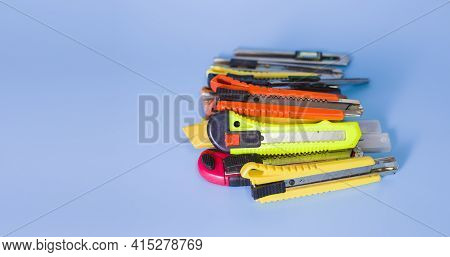 Several Old Paper Cutters Placed On A Blue Background.
