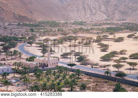 Small Mosque In The Rural Area Of Musandam Province Suburbs Of Bukha Village, Oman. Palm Trees In Th