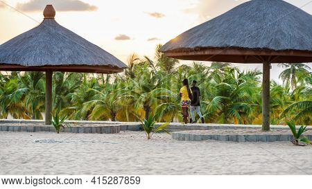 Young African Couple Walking On Walking Beach Road At Sunset In Keta Ghana West Africa, 2020 Novembe