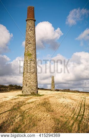 Chimneys Left Over From Tin Mining Stand In The Landscape Of Cornwall, Uk