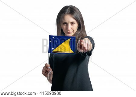 Happy Young White Woman Holding Flag Of Tokelau And Points Forward In Front Of Him Isolated On A Whi