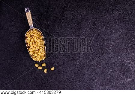 Traditional Dry Pasta On A Black Background. Design Concept. A Copy Of The Space. Selective Focus.
