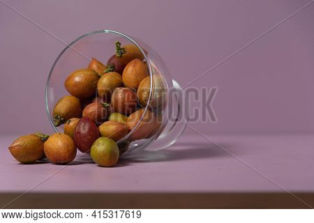 Caferana Fruits (bunchosia Armeniaca) In Natura Served In A Bowl On A Pink Background.