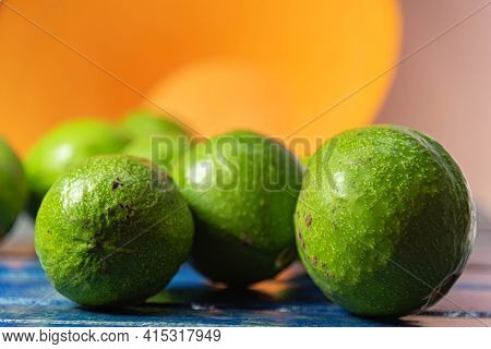 Natural Avocado Fruits (persea Americana) On Blue Wooden Surface