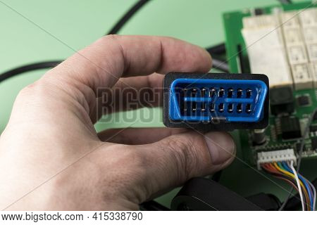 Electrician Holds In Hands Car Diagnostic Error Scanner Obd2 Plug. Computer Diagnostics Of Car Engin