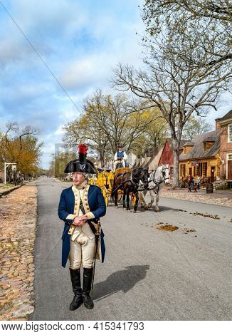 Williamsburg, Virginia, USA: 31st March 2021; Major General Marquis De Lafayette in downtown colonial Williamsburg talking as a carriage passes by.