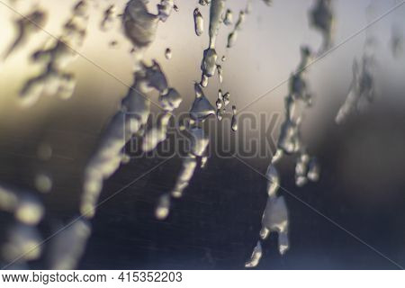 Frozen Drops Of Water On The Window Glass Of A Train Carriage In The Rays Of The Setting Sun