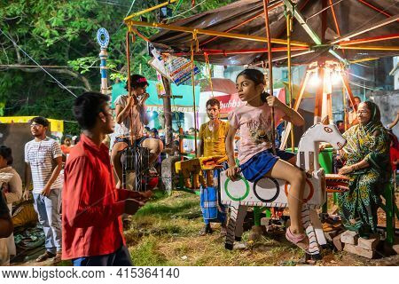 Howrah, West Bengal, India -14th April 2019: Girl Child Riding On Nagordola- A Traditional Amusement