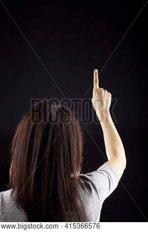 Behind The Head View Of A Young Caucasian Woman With Long Brown Hair Wearing Short Sleeve Shirt Agai