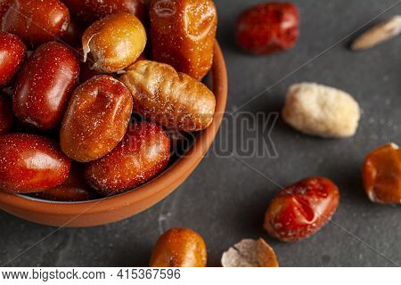 Ripe Fruits Of Cultivated Eleagnus (silverberry) Plants. The Nut Sized Brown Fruit Has A Thin Skin. 