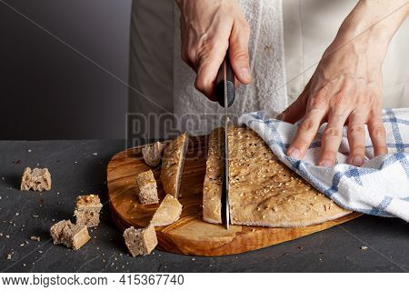A Woman Chef Is Slicing Fresh Baked Homemade Turkish Flat Bread Known As Pide Or Pita On Wooden Chop