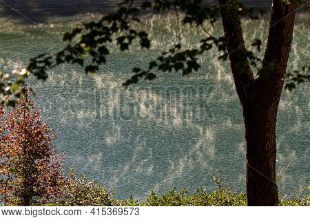 Early Morning Water Vapor Accumulation Over The Surface Of A Scenic Blue Lake. A Matter Of Changing 