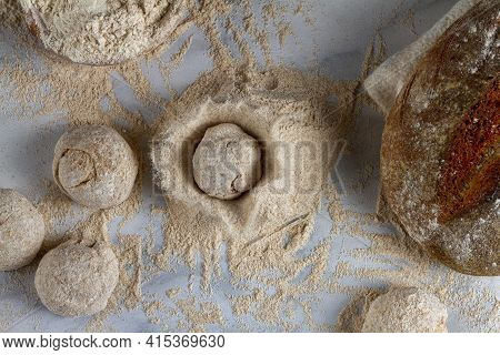 Flat Lay Image Of Bread Loaves, Dough Ingredients, A Bowl Of Flour, A Sourdough Bread On Marble Kitc