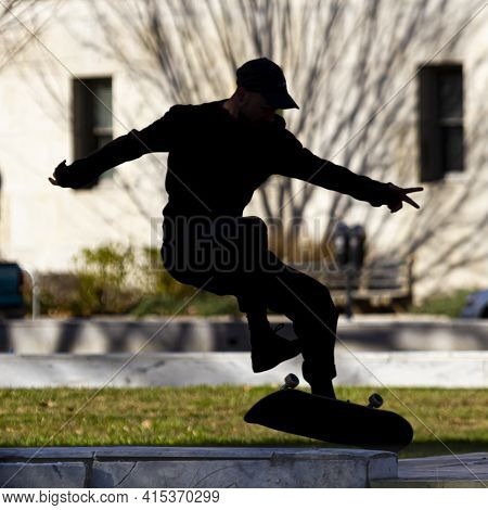 Washington Dc, Usa 11.28.2020: Backlit Close Up Image Showing The Silhouette Of A Skater In The Air 