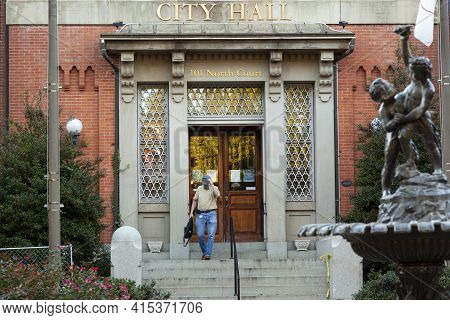 Frederick, Md, Usa 10/14/2020: A Middle Aged Male Employee Is Leaving The Historic City Hall Buildin