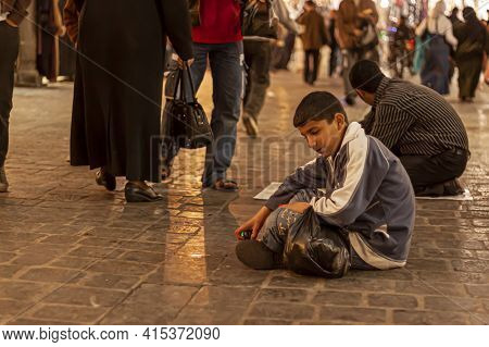 Damascus, Syria 03/28/2010: An Arabic Boy Is Sitting On The Floor Of Al Hamidiyah Souq (a Crowded Co