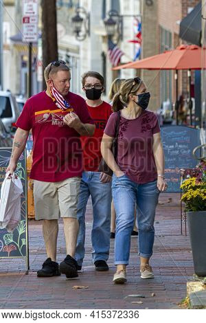 Ellicott City, Md, Usa 10/07/2020: A Caucasian Couple And Their Teenager Son Are Walking . Mom And S