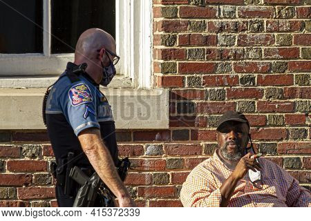 Ellicott City, Md, Usa 10/07/2020: A White Police Officer With Shaved Head Who Is Wearing  Short And
