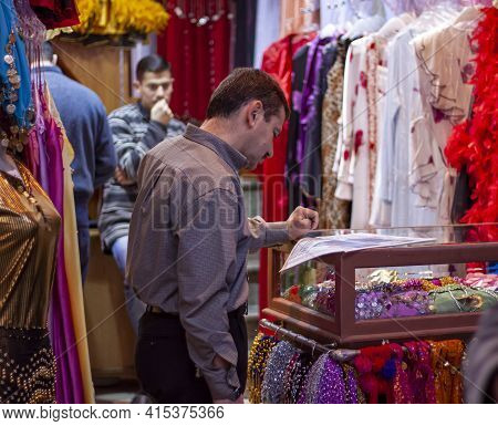 Damascus, Syria 03/28/2010: A Shop Keeper In Al Hamidiyah Souq Is Reading Newspaper While Standing A