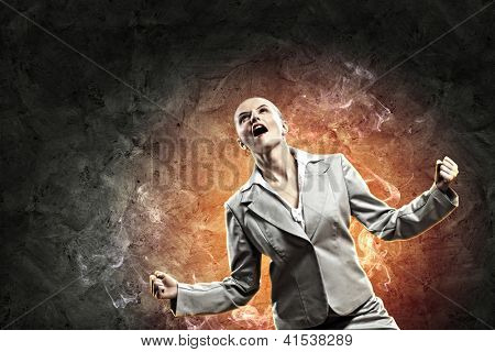 businesswoman in anger screaming against dark grey background