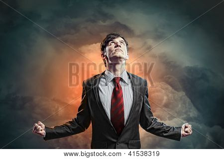 businessman in anger with fists clenched screaming