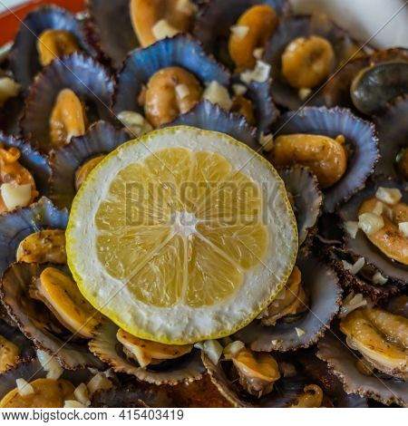 Tasty Seafood - Grilled Limpets Served With Lemon. Lapas Grelhadas. Azores Traditional Dish And A Ty