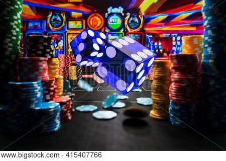 Casino rolling dice and chips on the gamblingtable