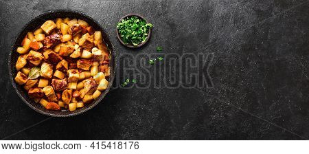 Meat Stew With Potato On Black, Top View, Copy Soace. Homemade Pork Meat Hot Meal In Cast Iron Pan.