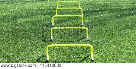 Five Yellow Mini Banana Hurdles In A Row For Runners To Perform Sports Drills Over During Speed And 