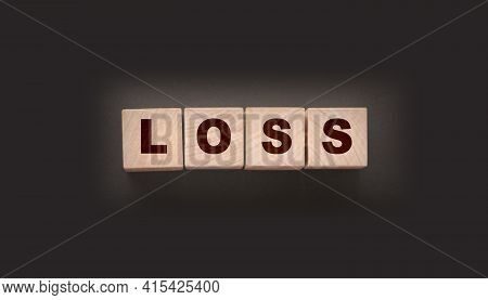 Wooden Cubes With Loss Word On Blacktable. Financial Loss Busines Concept