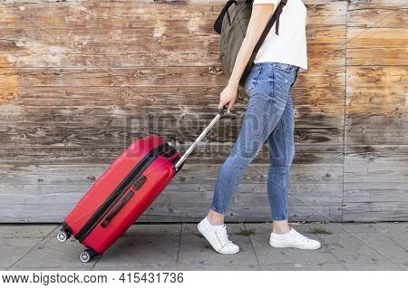 Side View Woman With Her Luggage . High Quality And Resolution Beautiful Photo Concept
