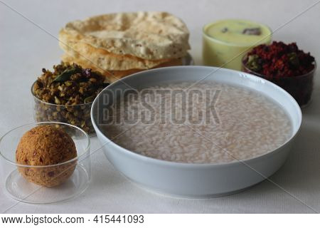 Rice Porridge Or Kanji Along With Coconut Chutney, Beetroot Potato Thoran, Stir Fried Moong, Fried P