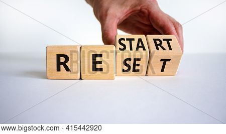 Reset And Restart Symbol. Businessman Hand Turns Cubes And Changes The Word 'reset' To 'restart'. Be