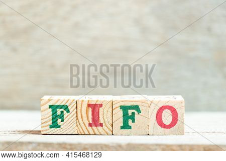 Alphabet Letter Block In Word Fifo (abbreviation Of First In First Out) On Wood Background